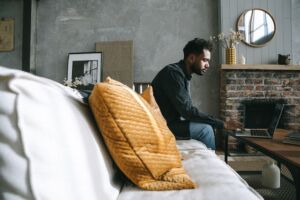 man sitting on couch by himself