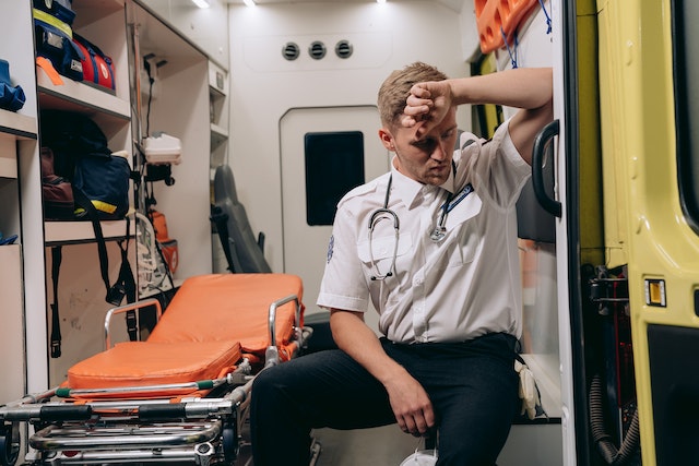 ems worker sitting in ambulance