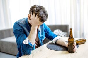 depressed man holding a bottle